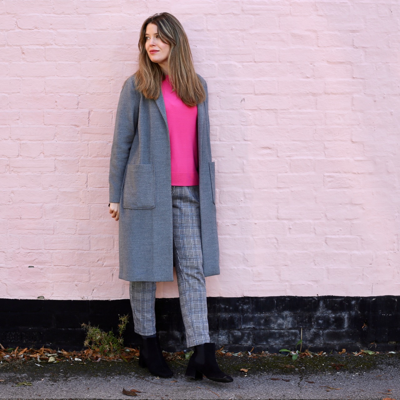 Pink jumper and grey trousers