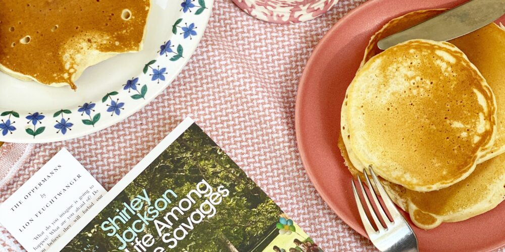 Book at the breakfast table of pancakes and tea